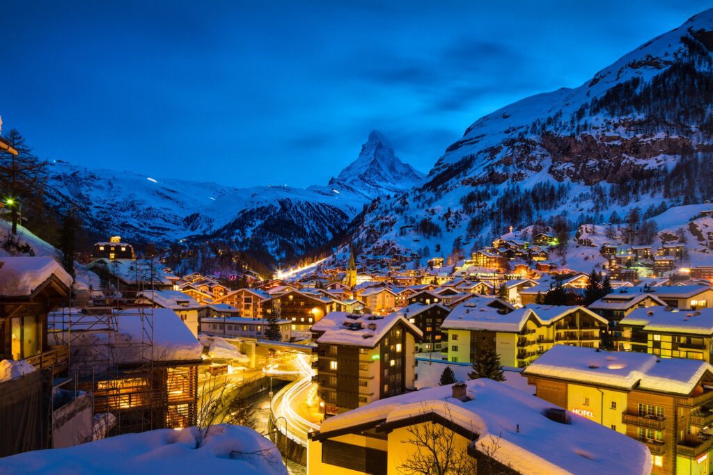 The Best Winter Holiday Destinations | Elect Chauffeurs ski resort at night with area lit up