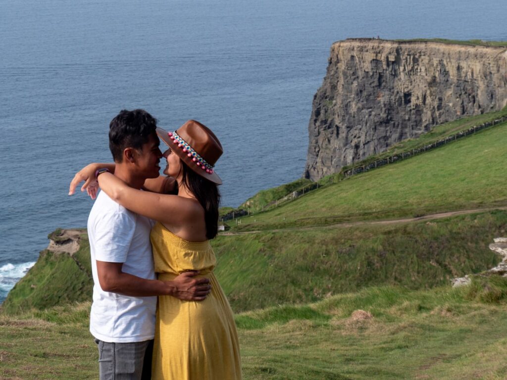 How To Plan Your Perfect Irish Honeymoon | Elect Chauffeurs beautiful couple at the cliffs of moher